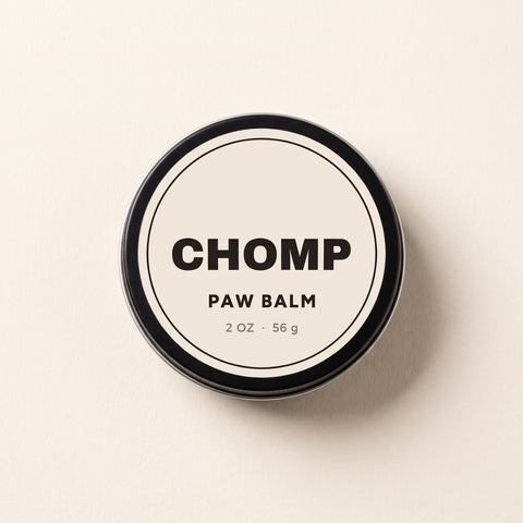 CHOMP Paw Balm tin, closed, on a light surface