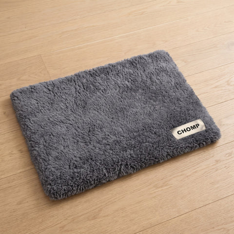 CHOMP Self-Warming Pet Pad on a wooden floor